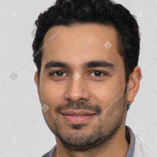 Joyful latino young-adult male with short  black hair and brown eyes