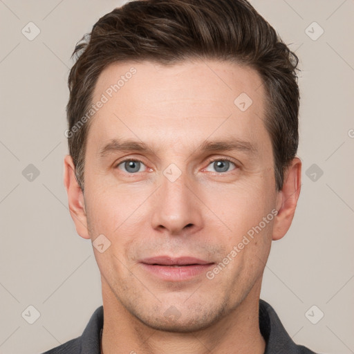 Joyful white young-adult male with short  brown hair and grey eyes