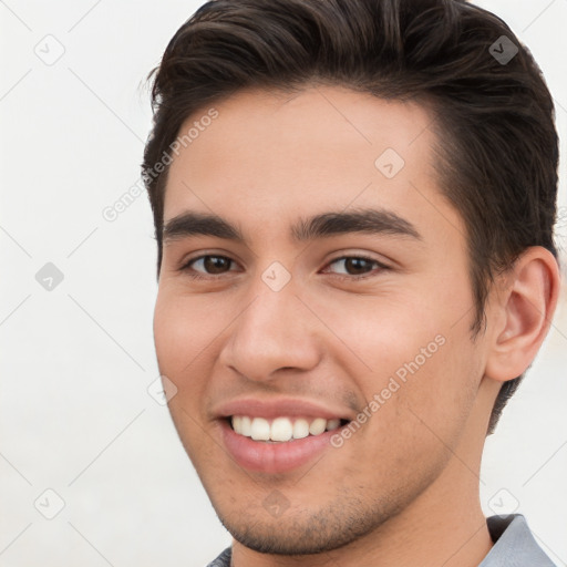 Joyful white young-adult male with short  brown hair and brown eyes