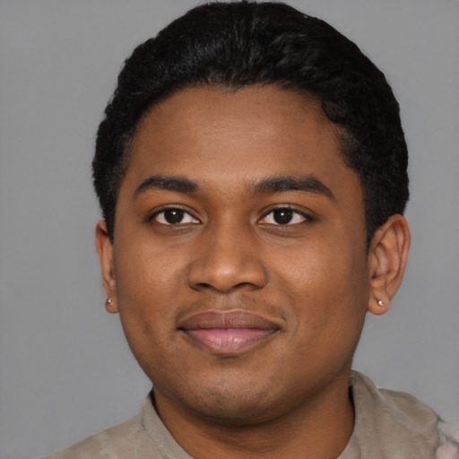 Joyful black young-adult male with short  black hair and brown eyes