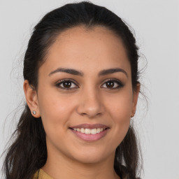 Joyful latino young-adult female with long  brown hair and brown eyes