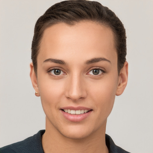 Joyful white young-adult female with short  brown hair and brown eyes