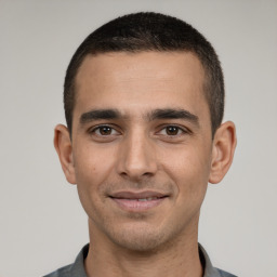 Joyful white young-adult male with short  black hair and brown eyes