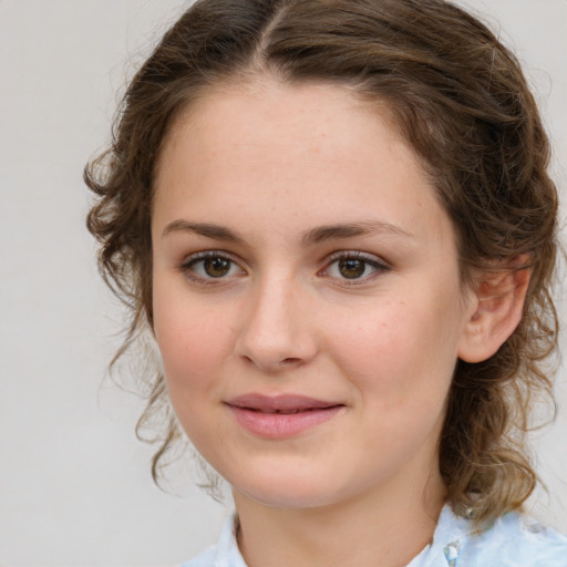 Joyful white young-adult female with medium  brown hair and green eyes