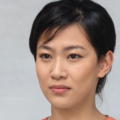 Joyful asian young-adult female with medium  black hair and brown eyes