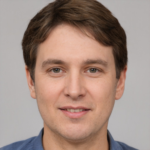 Joyful white adult male with short  brown hair and grey eyes