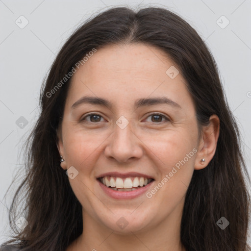 Joyful white adult female with long  brown hair and brown eyes