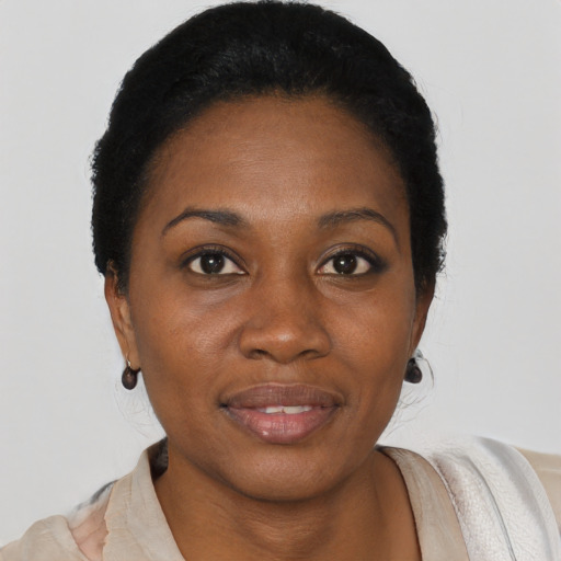 Joyful black young-adult female with short  black hair and brown eyes