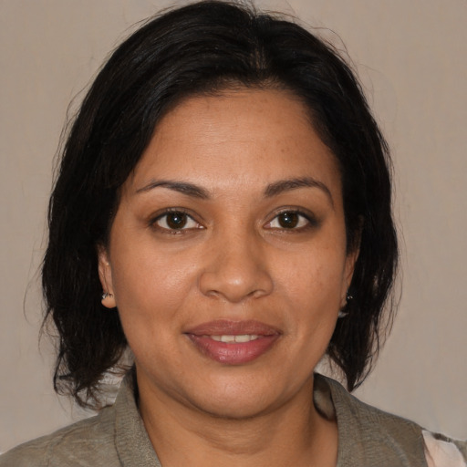 Joyful black adult female with medium  brown hair and brown eyes