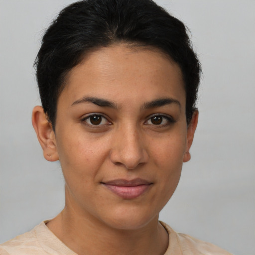 Joyful latino young-adult female with short  brown hair and brown eyes
