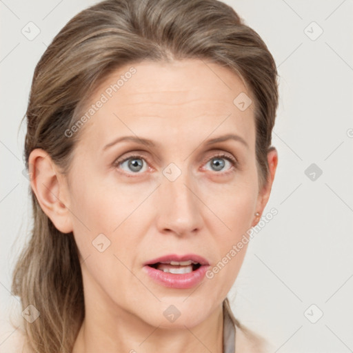 Joyful white adult female with medium  brown hair and grey eyes