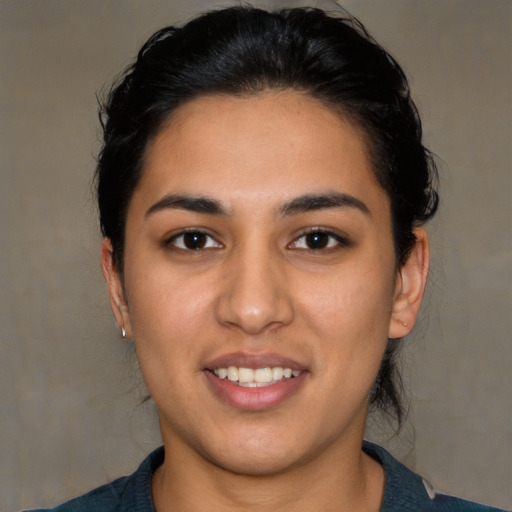 Joyful latino young-adult female with short  brown hair and brown eyes