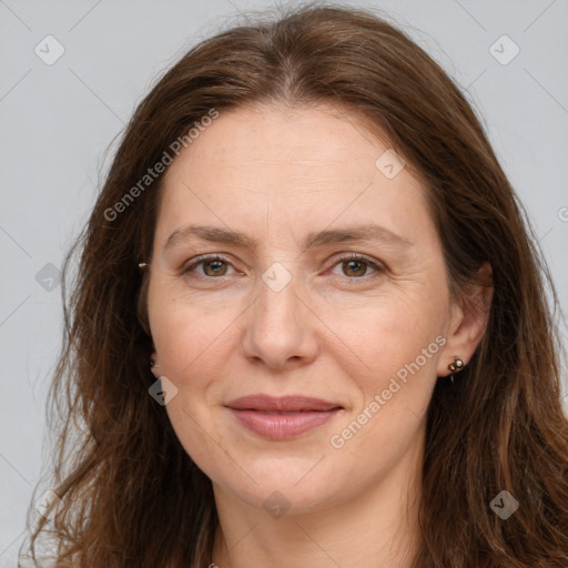 Joyful white adult female with long  brown hair and brown eyes