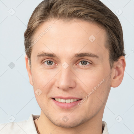 Joyful white young-adult male with short  brown hair and brown eyes