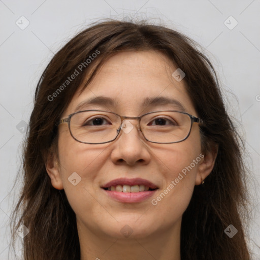 Joyful white adult female with long  brown hair and brown eyes