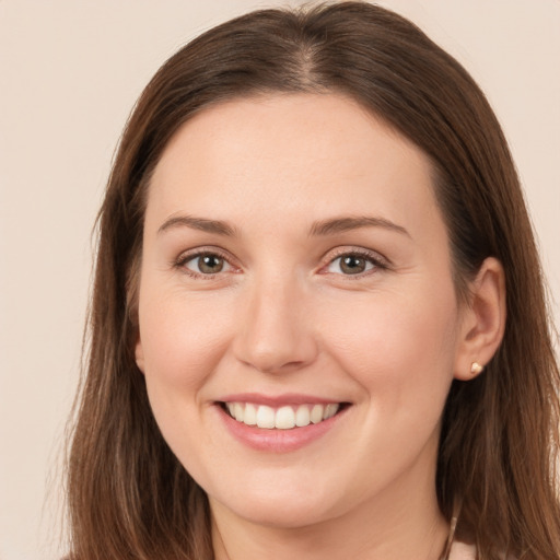 Joyful white young-adult female with long  brown hair and brown eyes