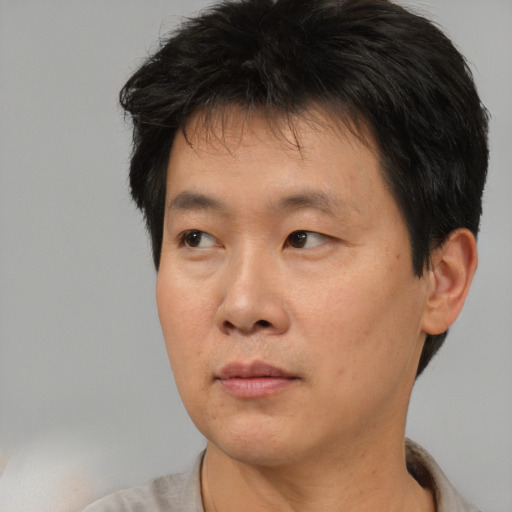 Neutral asian adult male with short  brown hair and brown eyes