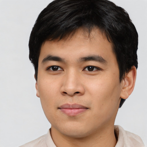 Joyful asian young-adult male with short  brown hair and brown eyes