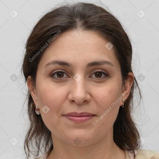 Joyful white adult female with medium  brown hair and brown eyes