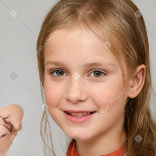 Joyful white child female with medium  brown hair and brown eyes