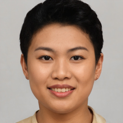 Joyful asian young-adult female with short  black hair and brown eyes