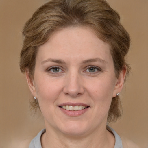 Joyful white adult female with medium  brown hair and brown eyes