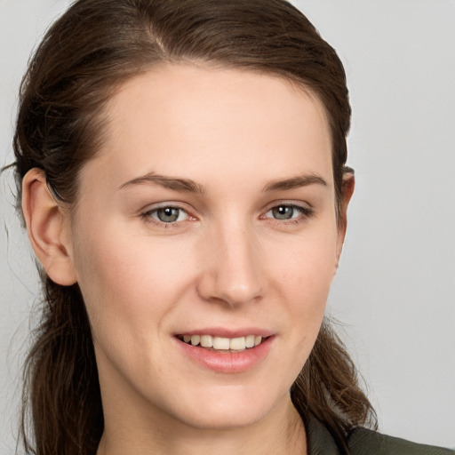 Joyful white young-adult female with long  brown hair and grey eyes