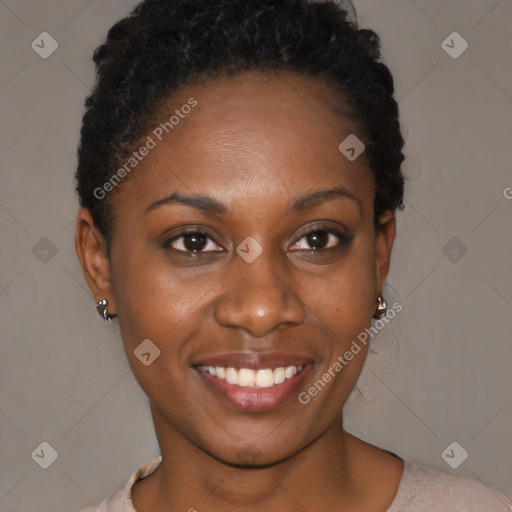 Joyful black young-adult female with short  black hair and brown eyes