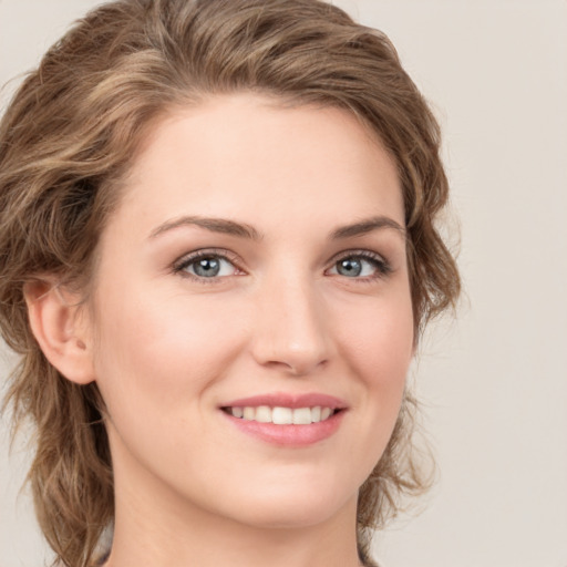 Joyful white young-adult female with medium  brown hair and green eyes