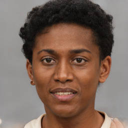 Joyful black young-adult male with short  brown hair and brown eyes