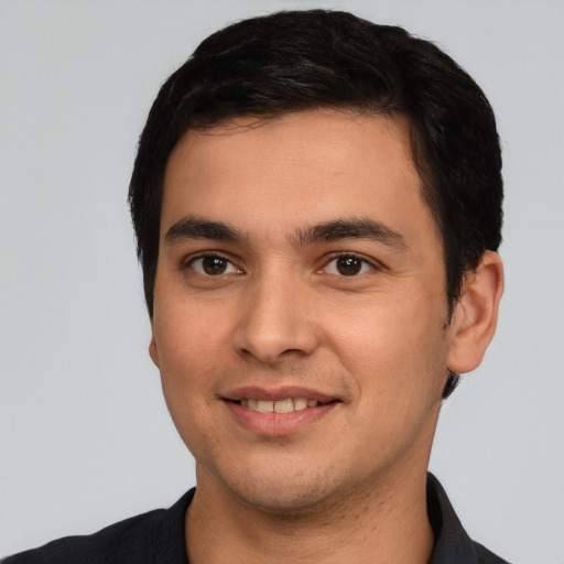 Joyful white young-adult male with short  black hair and brown eyes