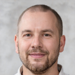 Joyful white adult male with short  brown hair and brown eyes