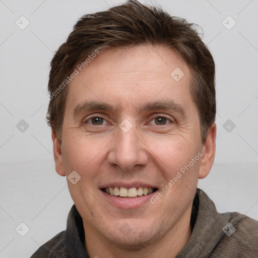 Joyful white adult male with short  brown hair and grey eyes