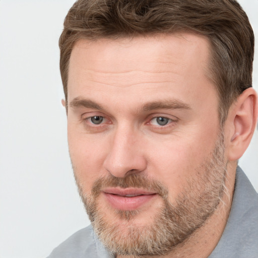 Joyful white adult male with short  brown hair and grey eyes