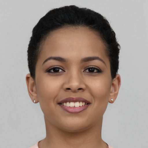 Joyful latino young-adult female with short  brown hair and brown eyes