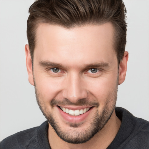 Joyful white young-adult male with short  brown hair and brown eyes