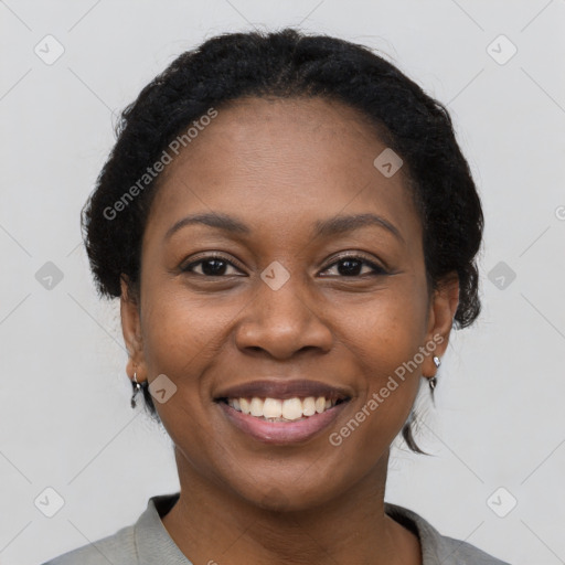 Joyful black young-adult female with medium  black hair and brown eyes