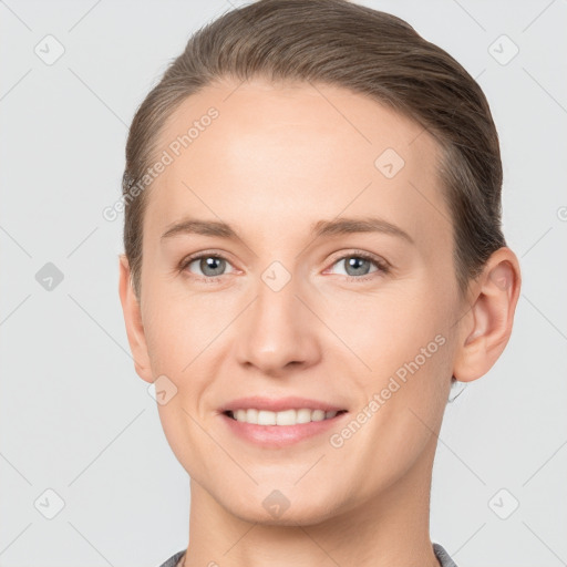 Joyful white young-adult female with short  brown hair and grey eyes