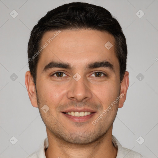 Joyful white young-adult male with short  black hair and brown eyes