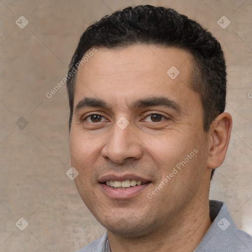 Joyful white adult male with short  black hair and brown eyes