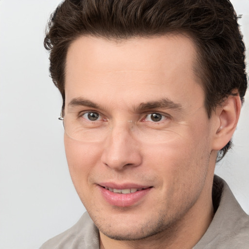 Joyful white adult male with short  brown hair and brown eyes