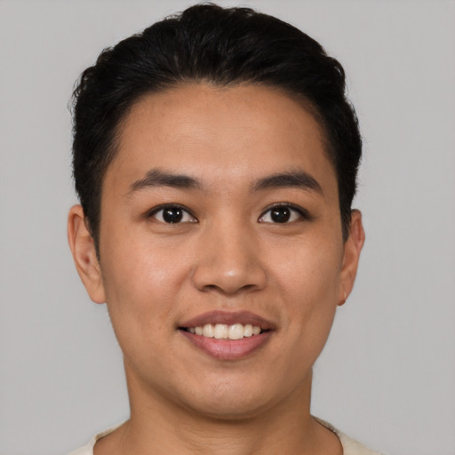 Joyful white young-adult male with short  black hair and brown eyes