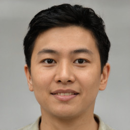 Joyful asian young-adult male with short  brown hair and brown eyes