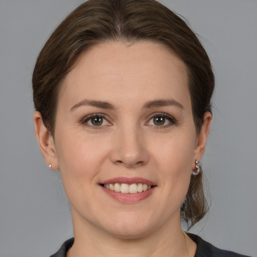 Joyful white young-adult female with medium  brown hair and brown eyes