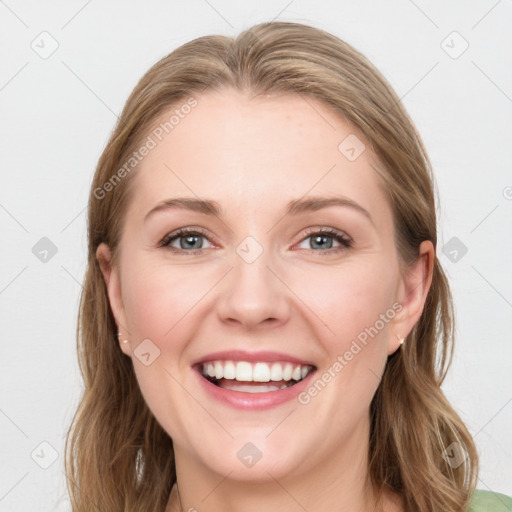 Joyful white young-adult female with long  brown hair and blue eyes