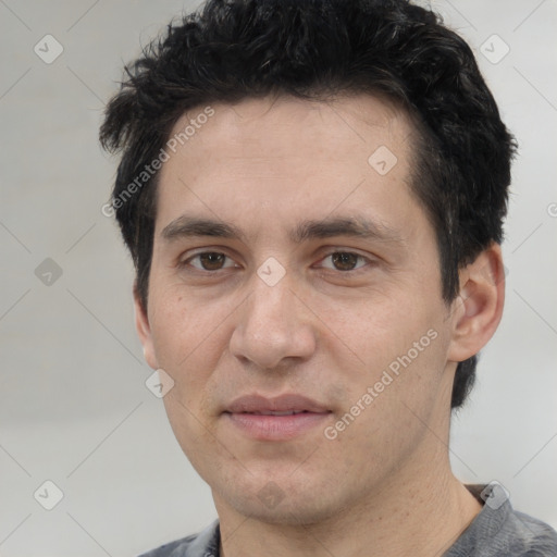 Joyful white adult male with short  black hair and brown eyes