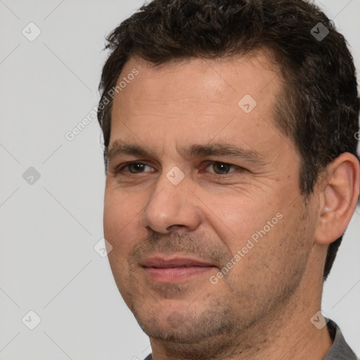 Joyful white adult male with short  brown hair and brown eyes