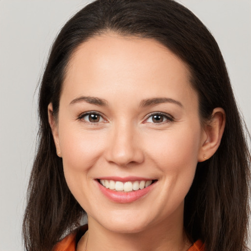 Joyful white young-adult female with long  brown hair and brown eyes