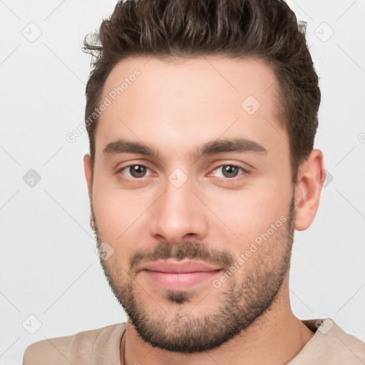 Joyful white young-adult male with short  brown hair and brown eyes