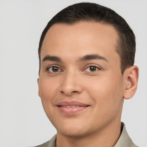 Joyful white young-adult male with short  black hair and brown eyes